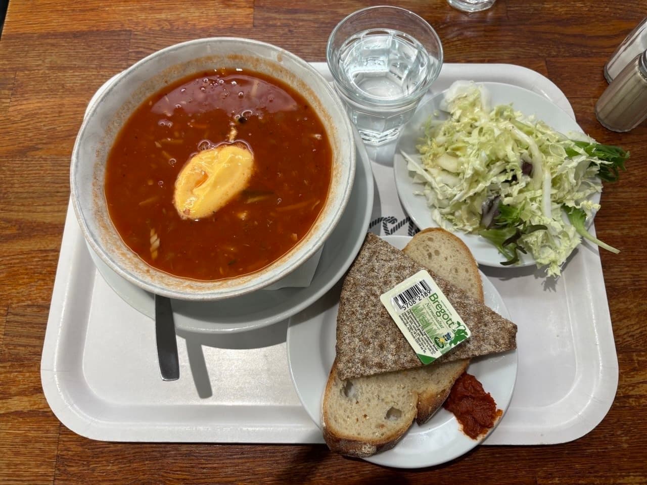 Fish soup with accompaniments of bread and salad